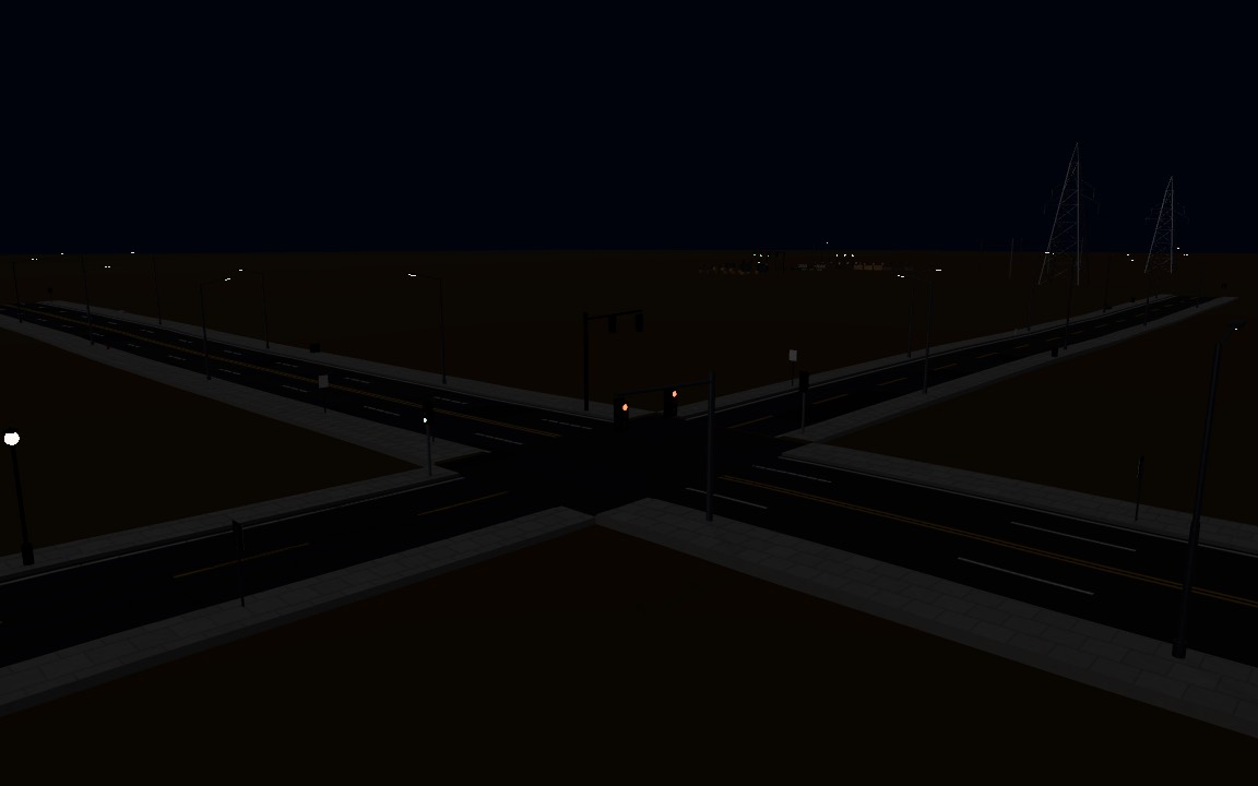Street lights and traffic lights glowing at a junction at night