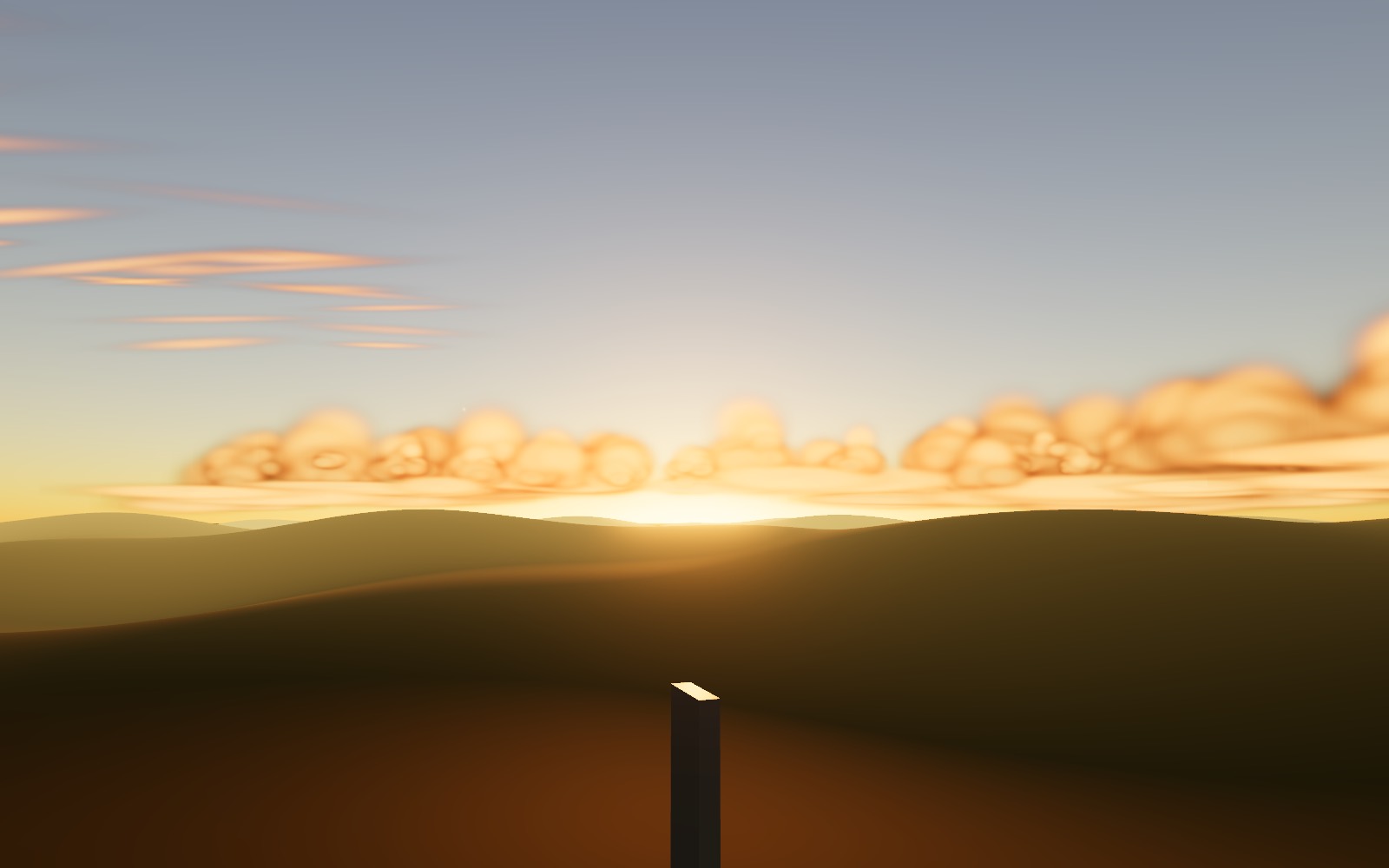 The sun setting behind hills, lighting cumulus, stratus and cirrus gold from below